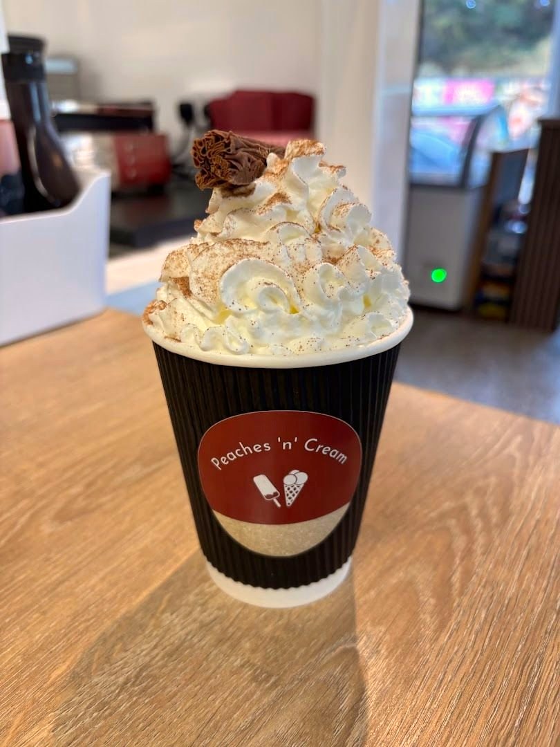 Hot chocolate in a Peaches 'n' Cream branded cup